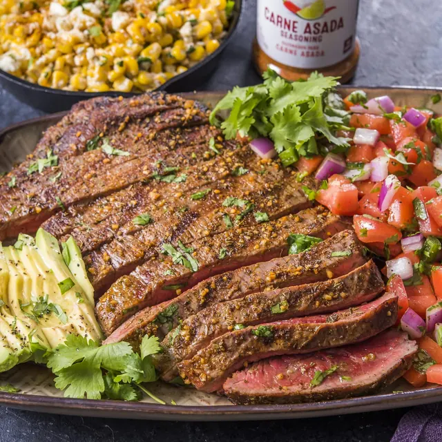 Carne asada with a bottle of seasoning